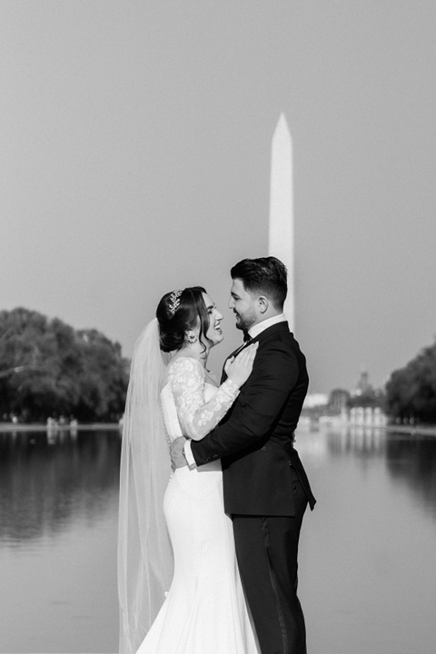 beautiful couple on their wedding day embracing in front of washington monument